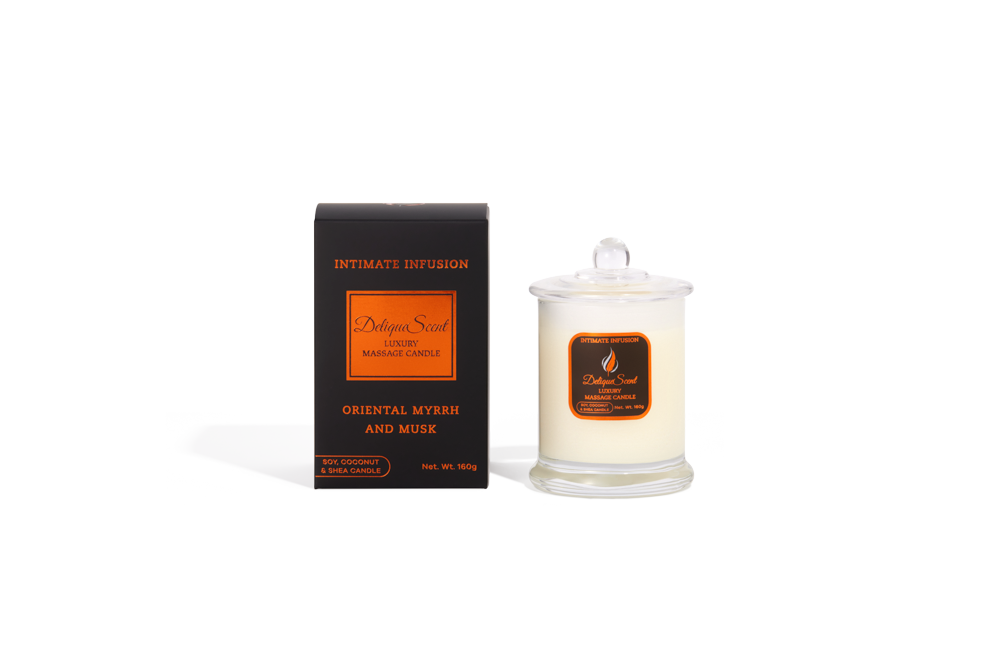 Body Safe, Organic Massage Candle in Intimate Infusion Scent, which is Oriental, Myrhh and Musk fragrance, Copper Highlights on a black box next to the glass massage candle.
