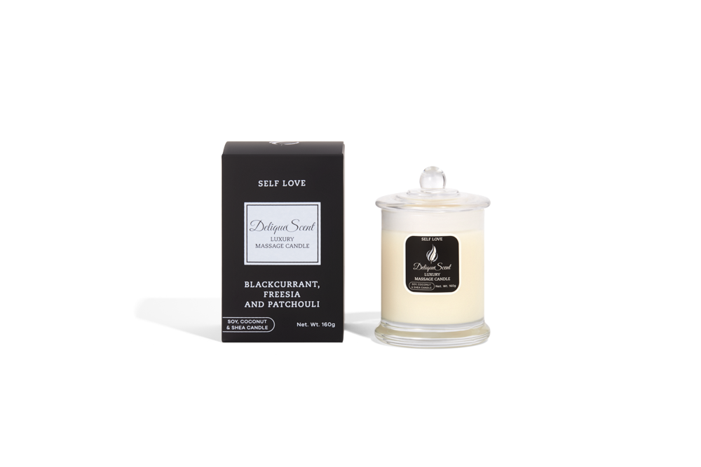 Body Safe, Organic Massage Candle in Self Love Scent, which is Blackcurrant , Fressia and Patchouli fragrance Silver Highlights on a black box next to the glass massage candle.