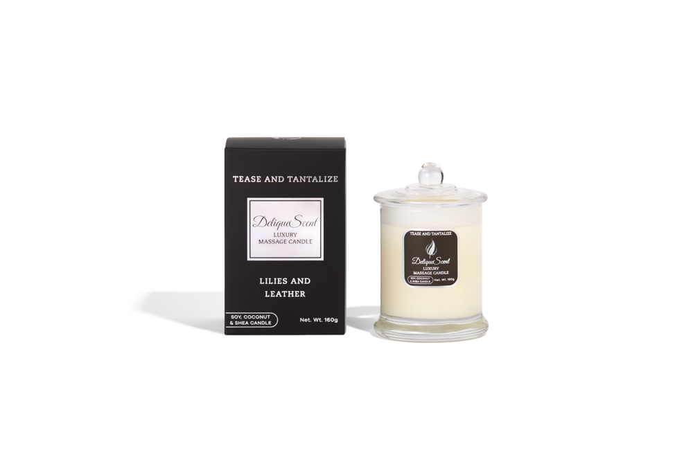 Body Safe, Organic Massage Candle in Tease and Tantalize Scent, which is Lillies and Leather fragrance White Highlights on a black box next to the glass massage candle.