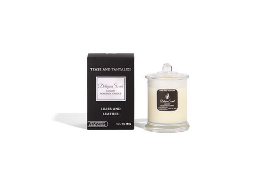 Body Safe, Organic Massage Candle in Tease and Tantalize Scent, which is Lillies and Leather fragrance White Highlights on a black box next to the glass massage candle.